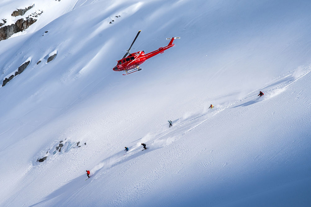 Skiers and Snowboarders Drop Into Deep Powder During a Helliskiing Adventure at Whistler Blackcomb