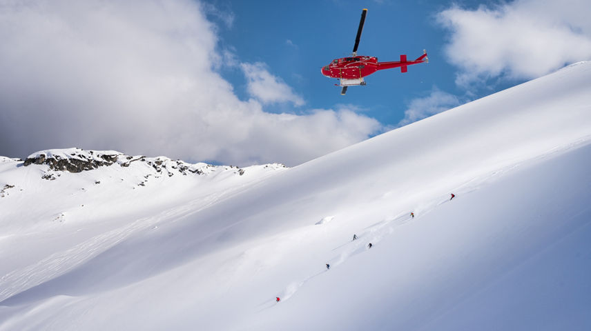 Skiers and Snowboarders Drop Into Deep Powder During a Helliskiing Adventure at Whistler Blackcomb