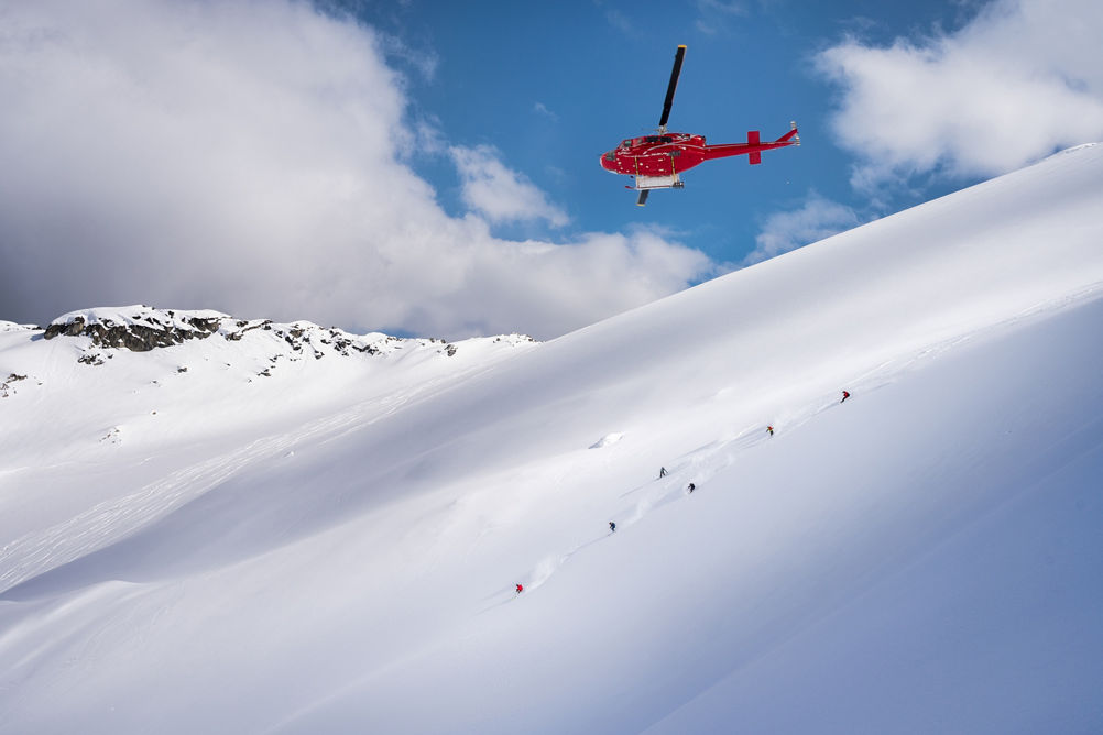 Skiers and Snowboarders Drop Into Deep Powder During a Helliskiing Adventure at Whistler Blackcomb