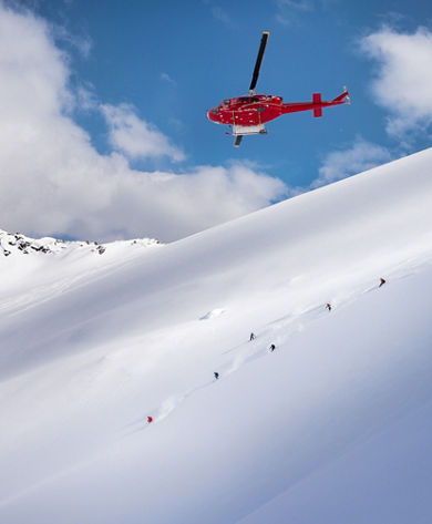 Skiers and Snowboarders Drop Into Deep Powder During a Helliskiing Adventure at Whistler Blackcomb