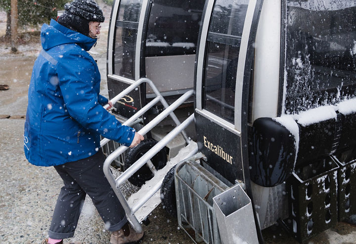 Employee Placing Rupert Roller in Excaliber Gondola at Whistler Blackcomb