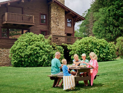 Family Enjoying a Picnic Lunch on a Summer Day While Staying at Birch Chalet at Seven Springs