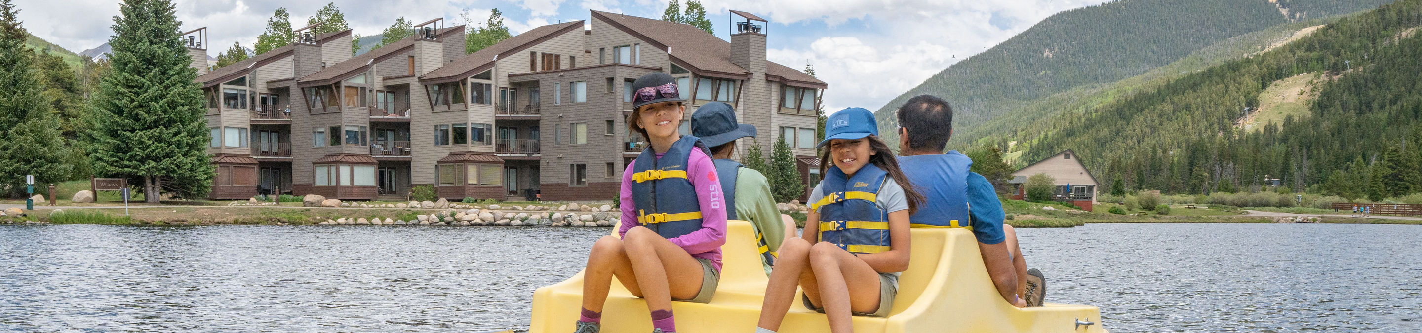 Family of Four Has Fun in Paddleboat at Keystone Lakeside Village