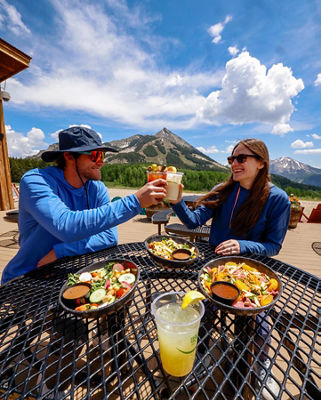 Friends Cheers Over Lunch at Umbrella Bar at Crested Butte 