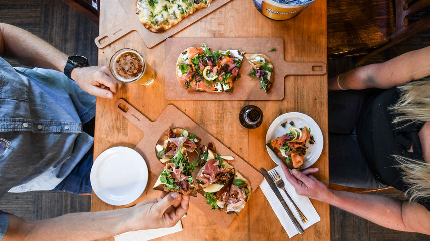Resort Guests Enjoy Flatbread Pizza and Beers at Merlin's Bar & Grill at Whistler Blackcomb