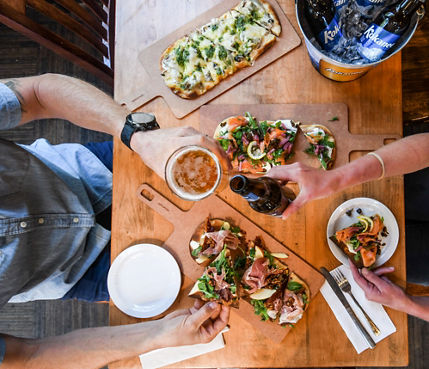 Resort Guests Enjoy Flatbread Pizza and Beers at Merlin's Bar & Grill at Whistler Blackcomb