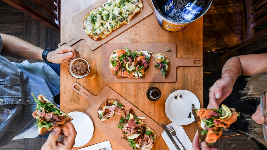 Resort Guests Enjoy Flatbread Pizza and Beers at Merlin's Bar & Grill at Whistler Blackcomb