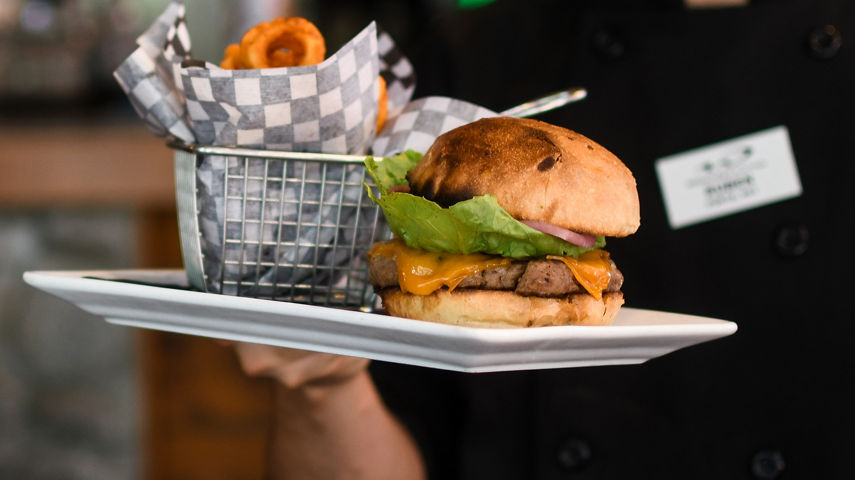 Employee Serves Dish at Merlin's Bar & Grill at Whistler Blackcomb
