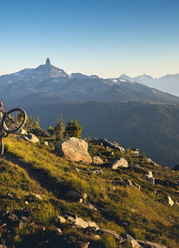 Mountain Biker Riding on High Alpine Terrain with Black Tusk in the Background at Whistler Blackcomb