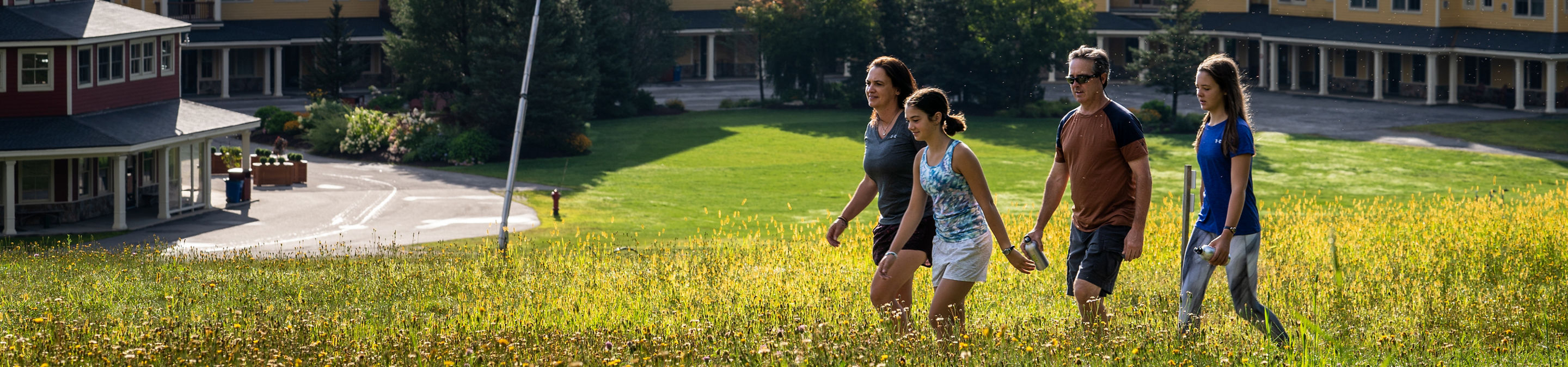 Family Hiking Outside a Jackson Gore Lodge at Okemo During Summer