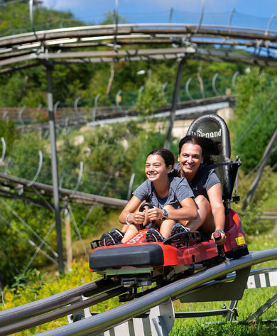 Mother and Daughter Ride Coaster at Okemo During Summer