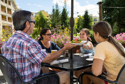 Family Enjoys Lunch Time Outdoors at Coleman Brook Tavern at Okemo During Summer