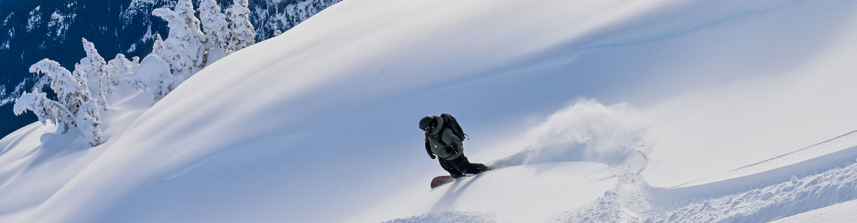 Whistler Heli-Skiing Participant Rides Down Advanced Terrain On a Bluebird Day Outside of Whistler Blackcomb
