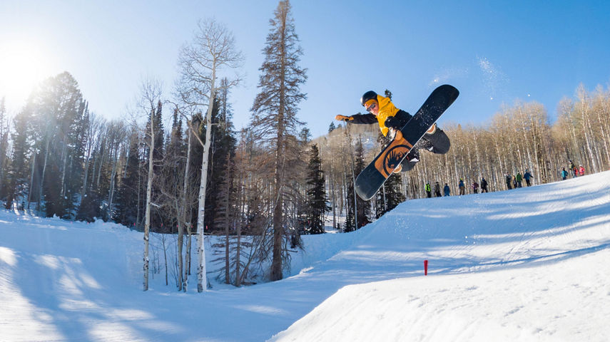 Snowboarder Jumps at Park City Terrain Park