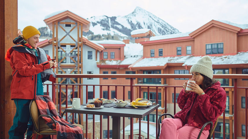 Friends Eat Breakfast and Drink Coffee on Balcony at Crested Butte
