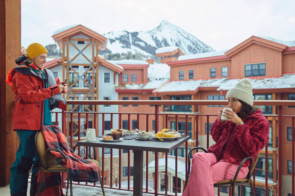 Friends Eat Breakfast and Drink Coffee on Balcony at Crested Butte