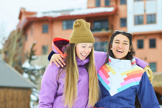 Friends Embrace While Walking to the Slopes at Crested Butte