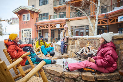 Friends Relax after Skiing Next to Firepit at Crested Butte
