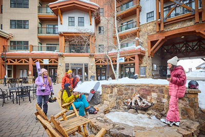 Friends Relax after Skiing Next to Firepit at Crested Butte