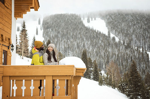 Couple Enjoying Hot Chocolates on Balcony at Vail Game Creek Clubhouse