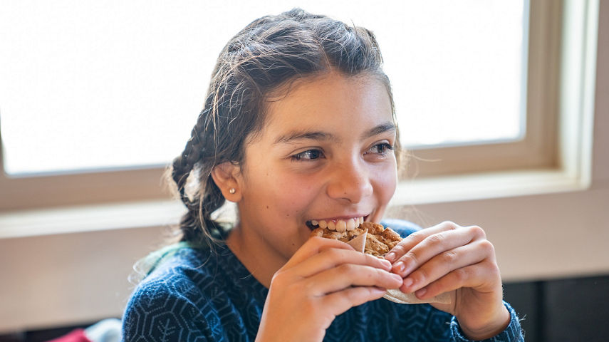 Young Girl Enjoys Eating a Cookie at Keystone's Summit House
