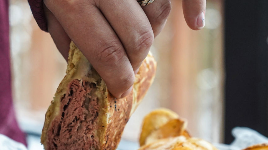 Guest Dips Sandwich at Wildcat Pub