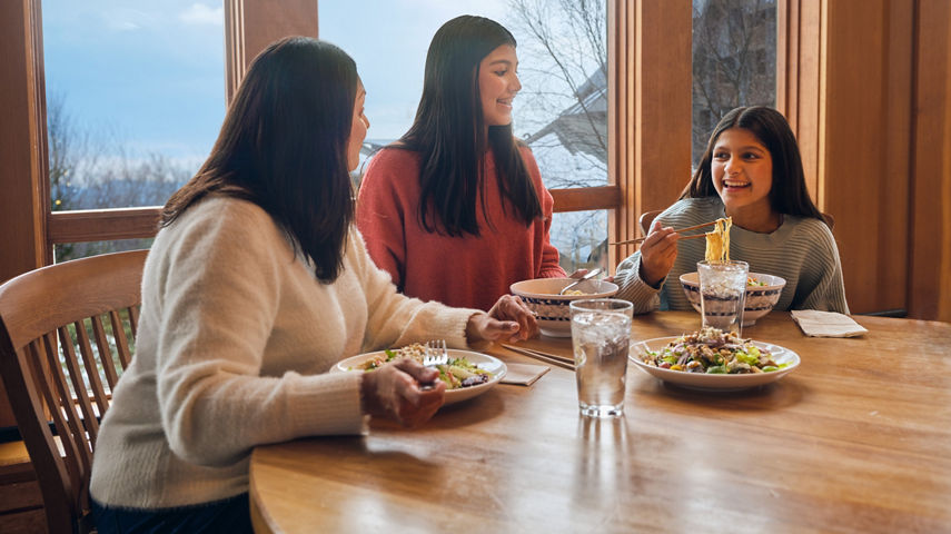 Mother and Daughters Eat Lunch at Dining Room Table in Stowe Lodge
