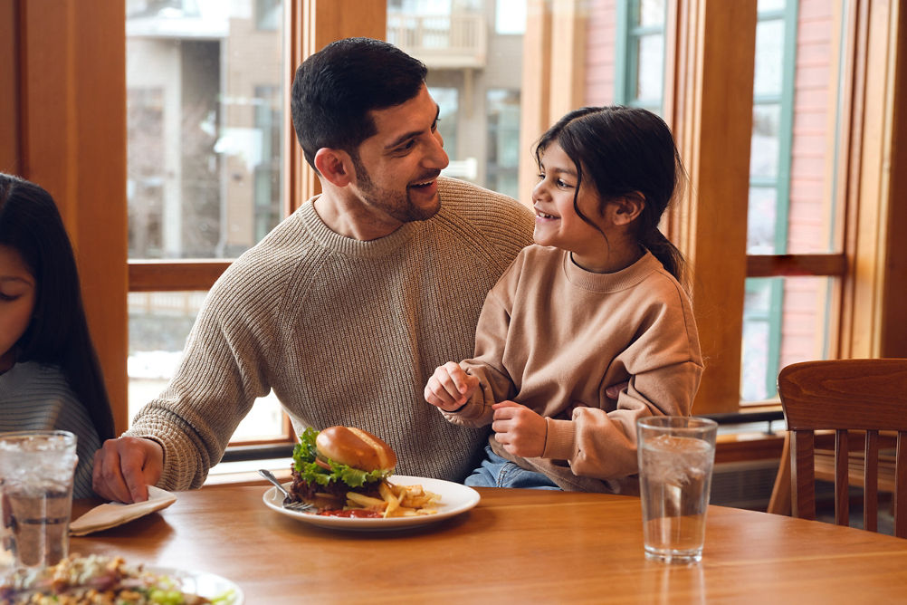 Father and Daughter Eat Lunch at Dining Room Table in Stowe Lodge