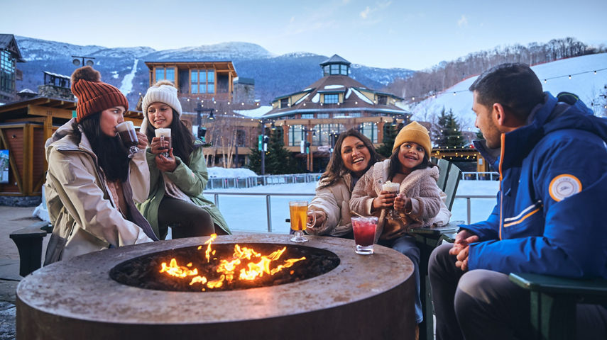 Family Around Firepit at Ice Skating Rink at Stowe
