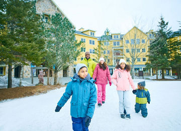 Family Walking Around Snowy Okemo Base Area