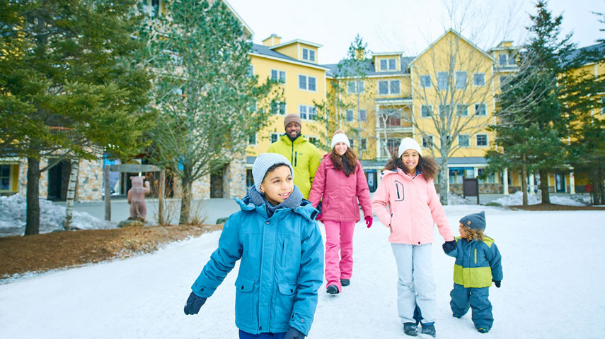 Family Walking Around Snowy Okemo Base Area