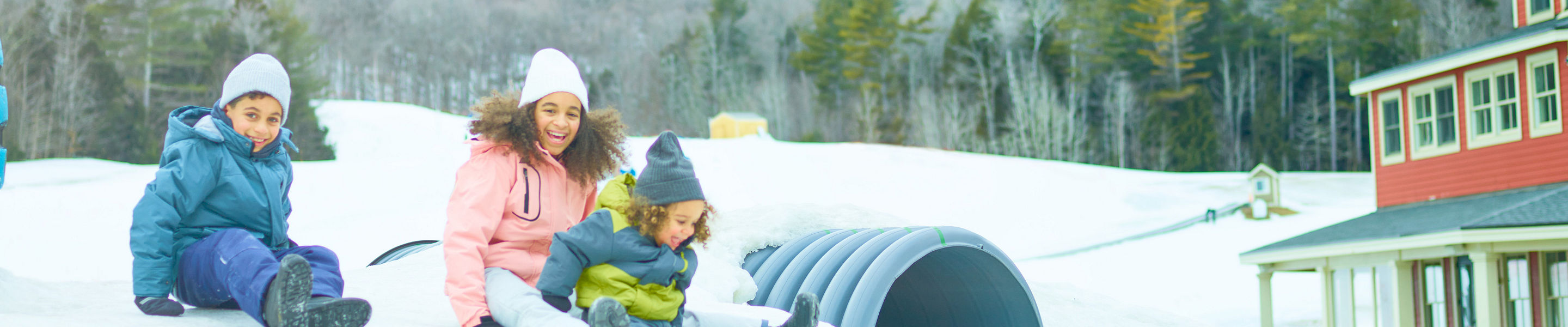 Siblings Slides Down Snowy Hill at Okemo