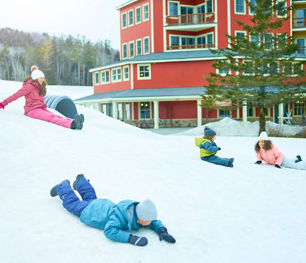 Family Slides Down Snowy Hill at Okemo