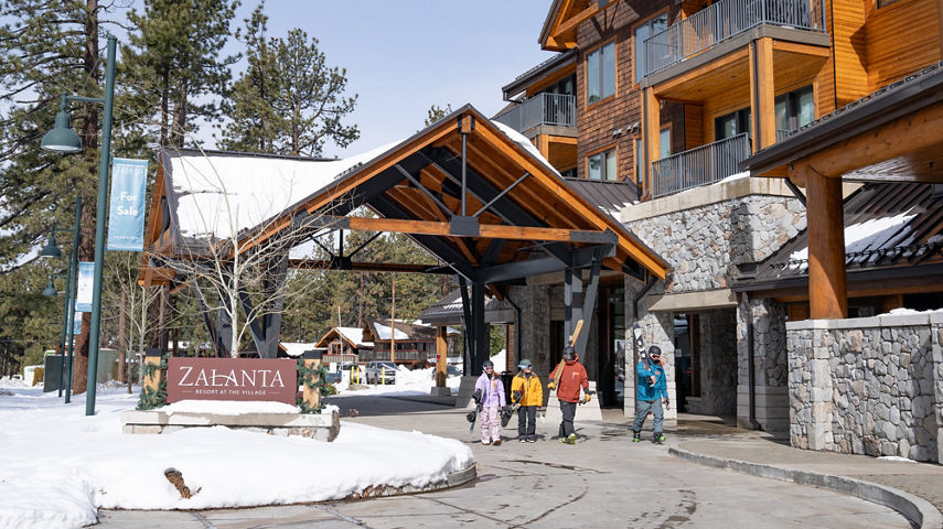 Group of Friends Walking Out of Zalanta Resort with Ski Gear at Heavenly