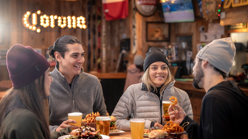 Group of Friends Dine at Whistler Blackcomb Merlin's Bar and Grill