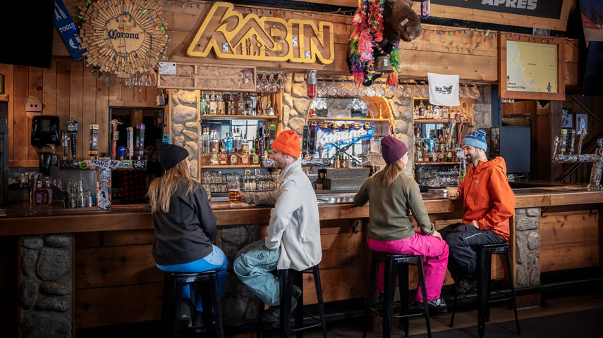 Couples Sit at Bar at Whistler Blackcomb Merlin's Bar and Grill