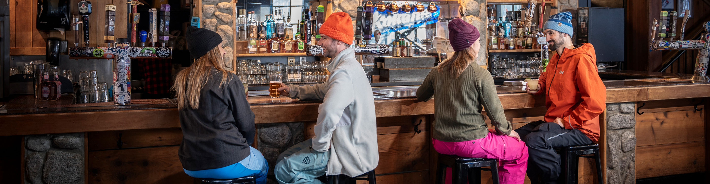 Couples Sit at Bar at Whistler Blackcomb Merlin's Bar and Grill