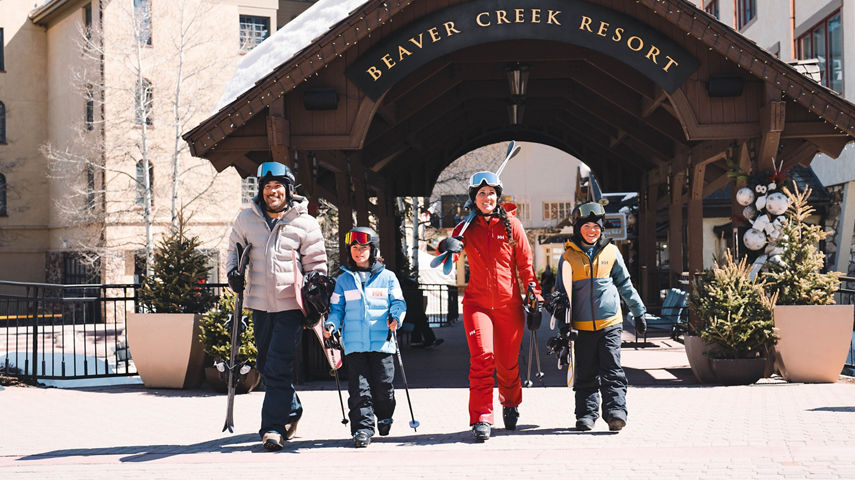 Family of 4 Exiting the Covered Bridge in Ski Attire