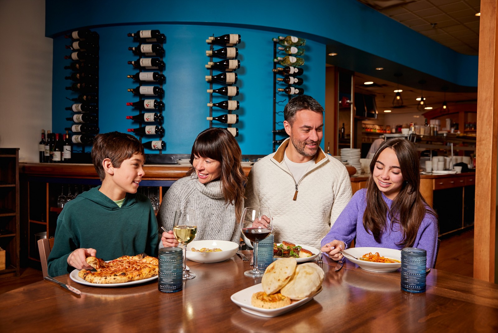 A family sharing dinner and conversation at Citrea in Beaver Creek Village