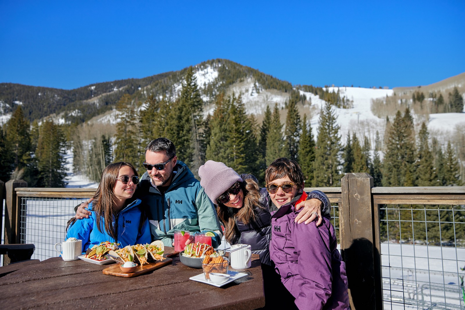 A family enjoying lunch on the sunny outdoor deck at Talons in Beaver Creek