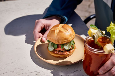 Burger with Pretzel Bun and Cocktail at Mamie's at Beaver Creek