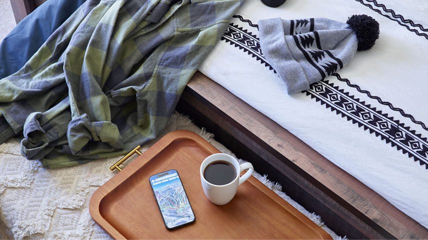 Bedroom Detail Shot of Clothes Draped Over Bed at Mountain Club at Kirkwood