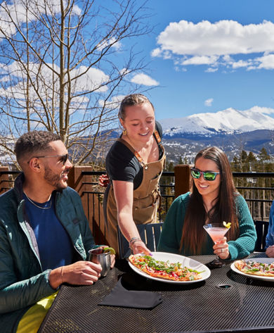 Employee Serves Group of Friends Lunch Outside at Breckenridge Sevens