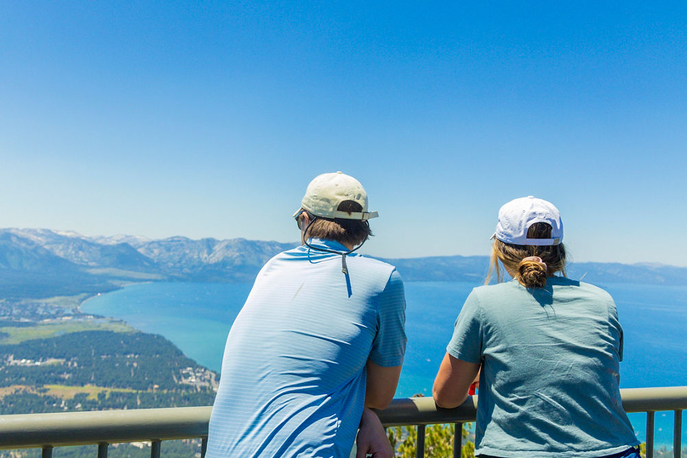 Friends Overlooking Scenic View of Lake Tahoe at Heavenly