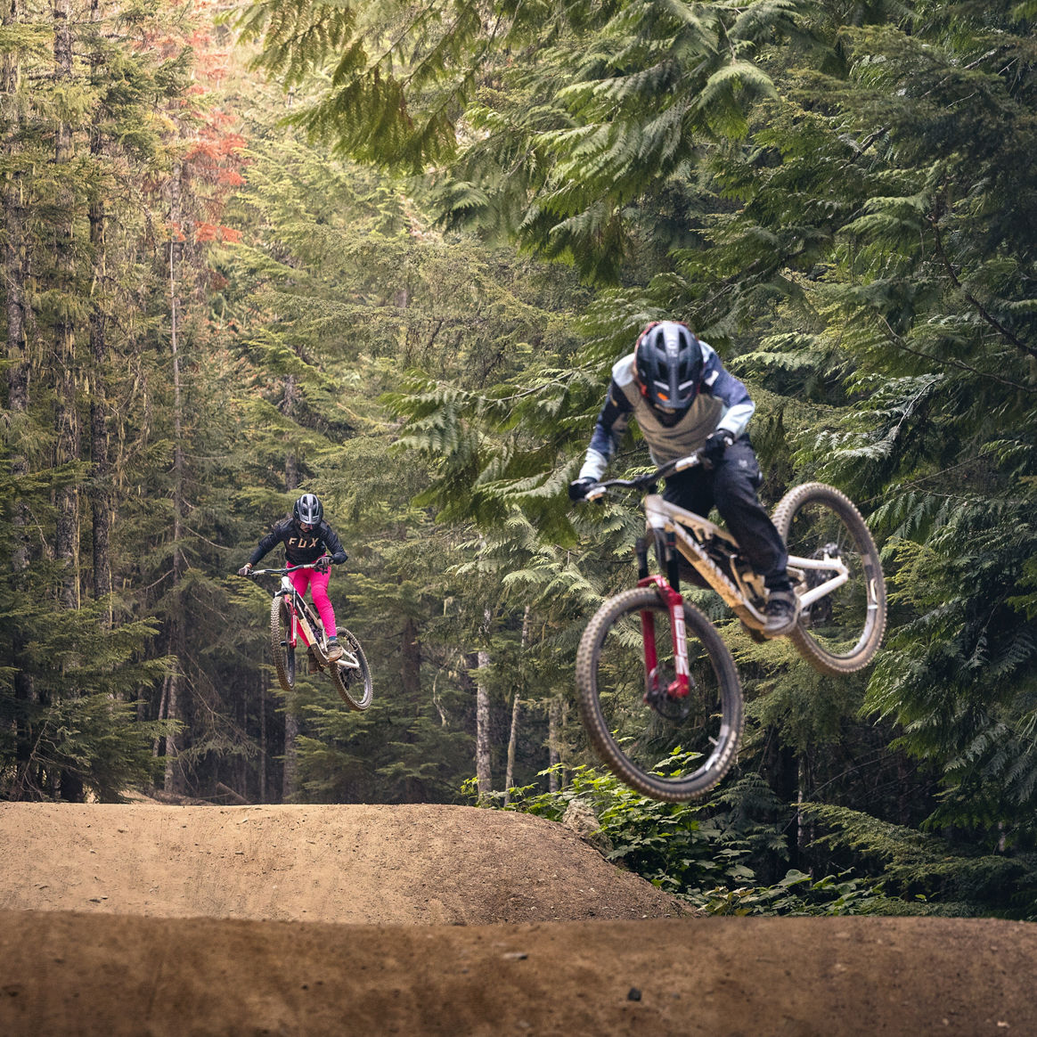 Bikers Riding Over Jumps at Whistler Blackcomb Bike Park