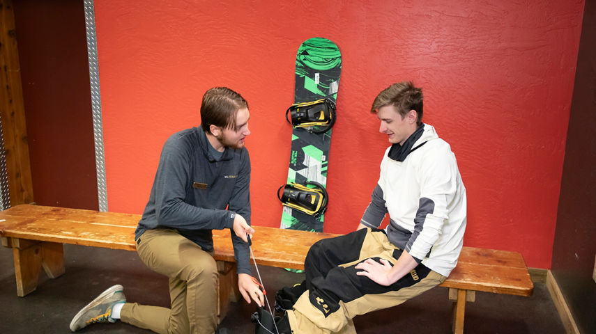 Seven Springs Employee Assisting Guest During Boot Fitting at Rental Center