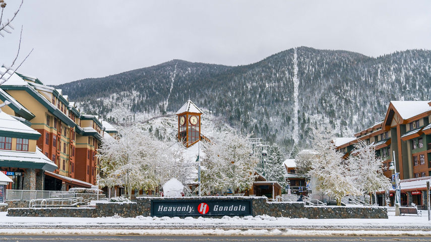 Heavenly Gondola Sign with Village and Clock Tower in Background