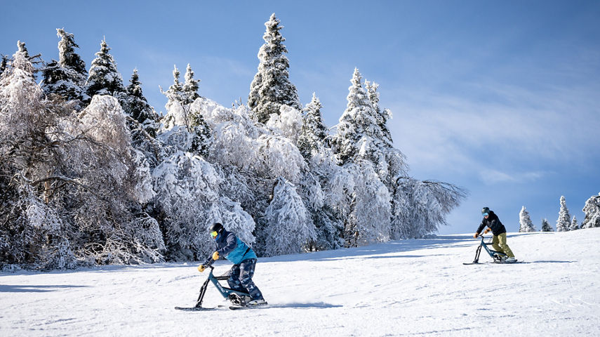 Resort Guests Skiing on Sno-Go Bikes at Mount Sunapee