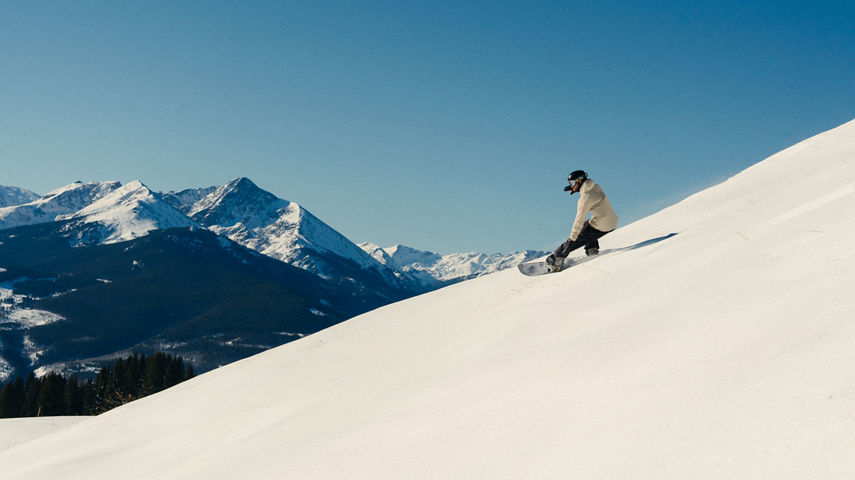 Snowboarder Riding Down Ptarmigan Ridge at Vail