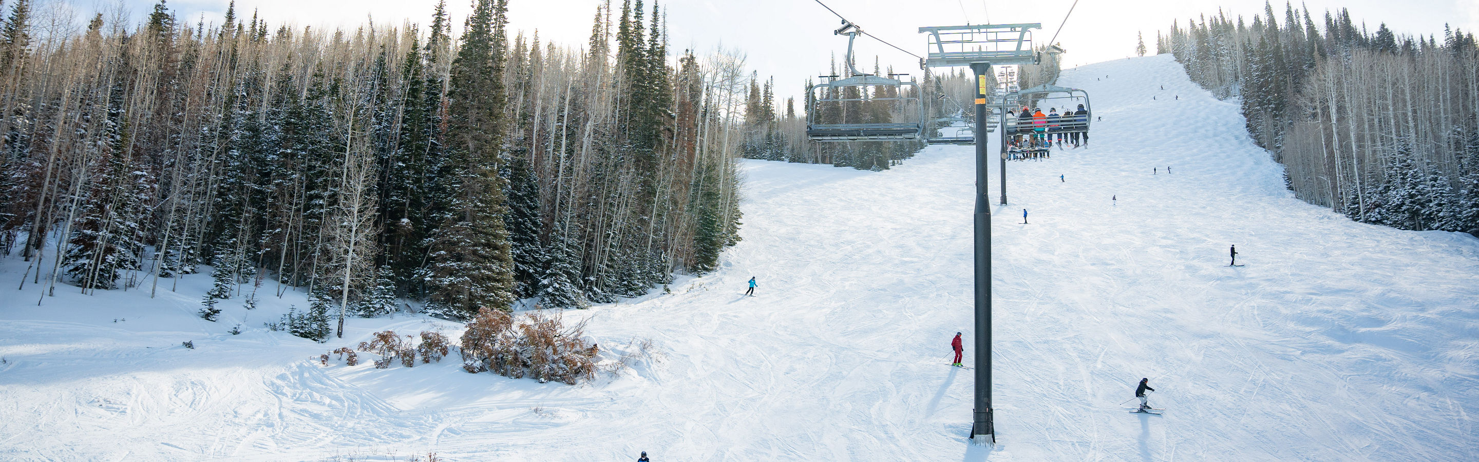 Skiers and Snowboarders Under Chairlift at Park City